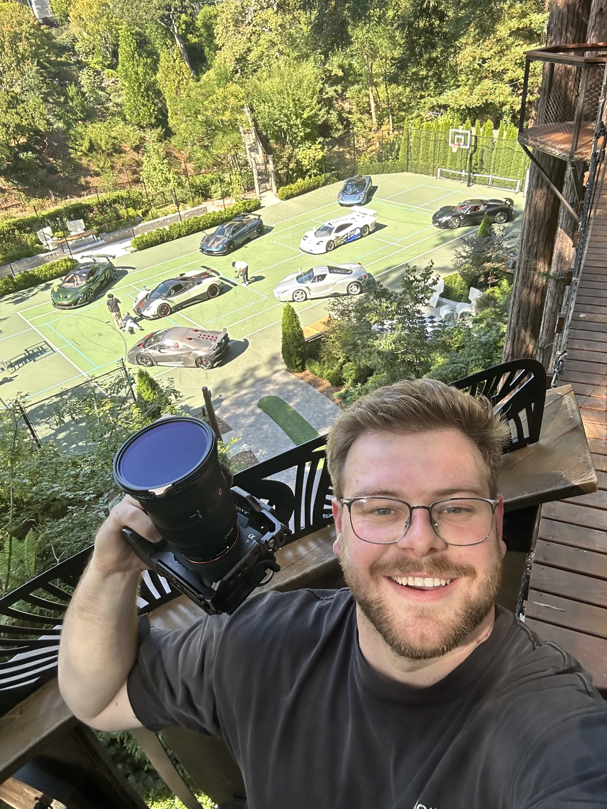Max holding his camera above the collection laid out on the court below