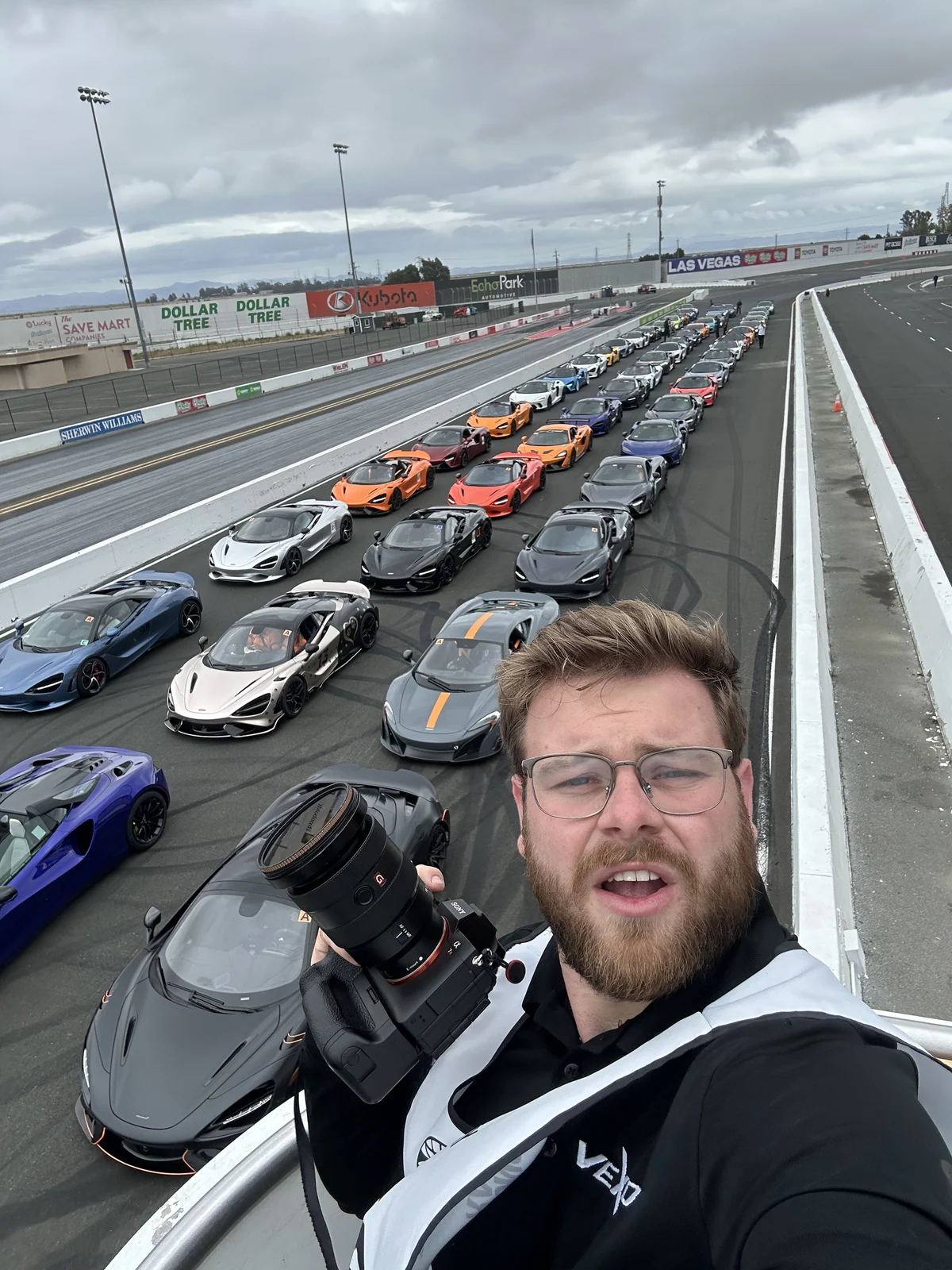 Max with his camera above a long line of supercars on the grid at Sonoma Raceway