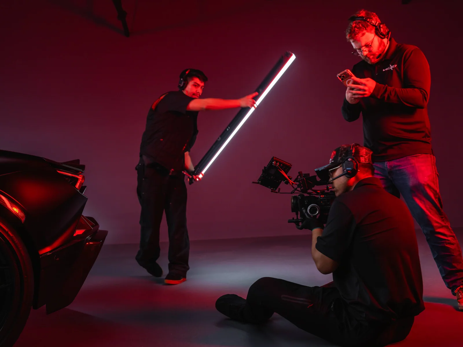Behind the scenes of a Lamborghini Revuelto shoot on a red studio set
